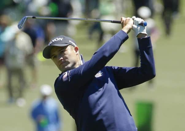 Russell Knox hits a shot on the first hole at  Augusta. Picture: AP