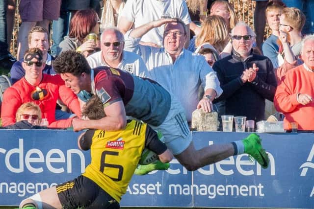 Austin Lockington of Melrose keeps hold of the ball in a challenge with Quins' Max Coyle in front of an appreciative crowd. Picture: Ian Georgeson