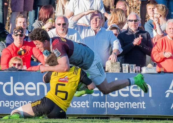 Austin Lockington of Melrose keeps hold of the ball in a challenge with Quins' Max Coyle  in front of an appreciative crowd. Picture: Ian Georgeson