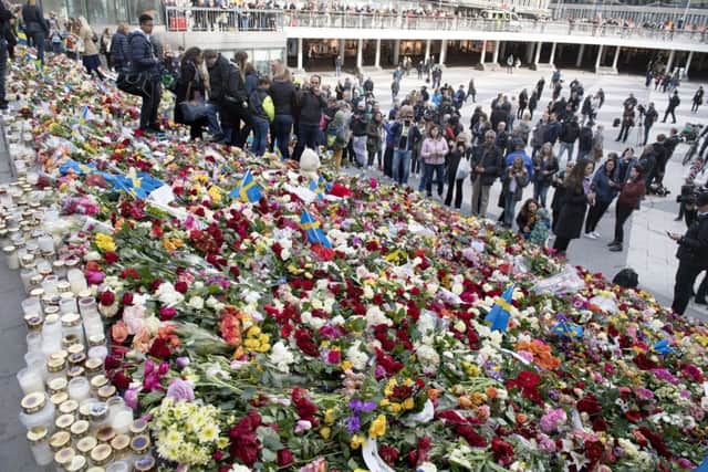 People leave flowers on the steps at Sergels Torg following Friday's attack in central Stockholm. Picture; AP