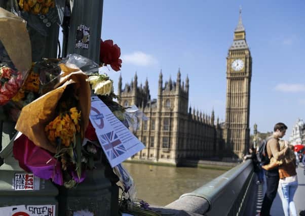 Flowers are seen at Westminster bridge to remember those that died during the terror attack. Picture; AP