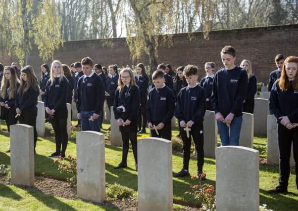 Scottish schoolchildren lay poppy crosses at the service at Faubourg dAmiens Cemetery, Arras. Picture: Warren Media