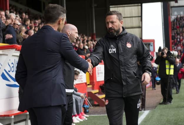 Aberdeen manager Derek McInnes, right, shakes hand with his counterpart Pedro Caixinha.