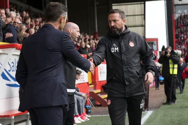Aberdeen manager Derek McInnes, right, shakes hand with his counterpart Pedro Caixinha.