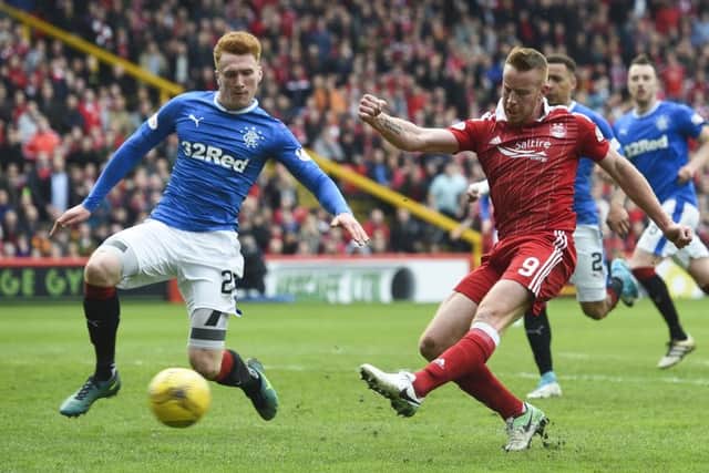 Aberdeen's Adam Rooney (right) shoots for goal with David Bates in close attendance. Picture: SNS