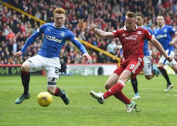 Aberdeen's Adam Rooney (right) shoots for goal with David Bates in close attendance. Picture: SNS