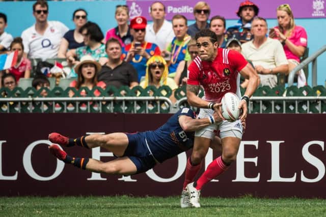 Scotland's James Fleming tackles France's Pierre Gilles Lakafia during the Challenge Trophy semi-finals at the Hong Kong Sevens. Picture: Getty