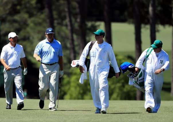 Ernie Els, second left, walks up the 17th hole with playing partner Jeff Knox. Picture: Getty.