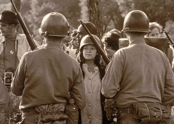 A young female protester wearing a helmet faces down armed police officers at an anti-Vietnam War demonstration outside the 1968 Democratic National Convention, Chicago. Picture: Hulton Archive/Getty Images
