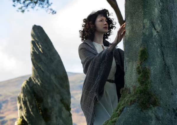 Claire Randall Fraser, played by Caitriona Balfe, travels through hundreds of years in time after touching fictional standing stones at Craigh na Dun in the first season of Outlander. PIC: Sony Pictures/Ed Miller.