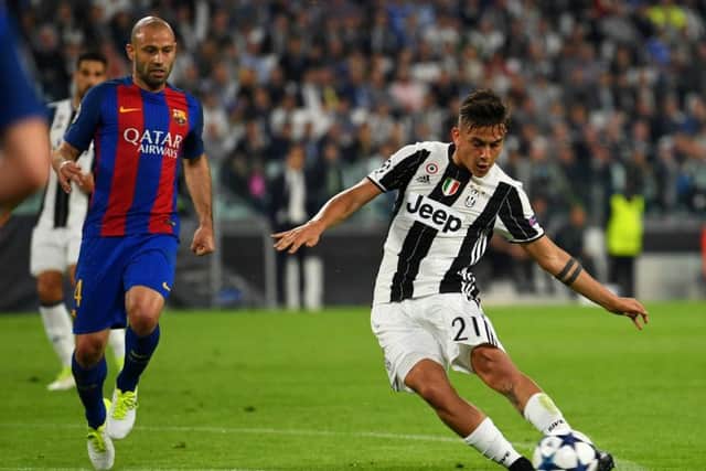 Paulo Dybala of Juventus scores his sides second goal against Barcelona last night. Picture. Getty.