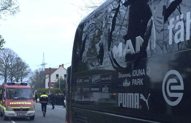 A window of the bus of Borussia Dortmund is damaged after an explosion (Carsten Linhoff/dpa via AP)