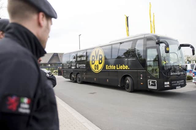 A team bus arrives at the training grounds of Borussia Dortmund the day after a team bus was damaged in an explosion which injured a player and a police officer. (Marius Becker/dpa via AP)