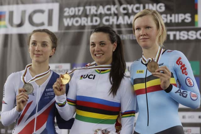 Gold medallist Rachele Barbieri, centre, of Italy, silver medalist Elinor Barker, left, of Great Britain and Bronze medalist Jolien D'Hoore of Belgium pose with their medals on the podium after the scratch race at the Track Cycling World Cup in Hong Kong. Picture: Kin Cheung/AP