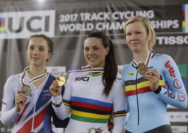 Gold medallist Rachele Barbieri, centre, of Italy, silver medalist Elinor Barker, left, of Great Britain and Bronze medalist Jolien D'Hoore of Belgium pose with their medals on the podium after the scratch race at the Track Cycling World Cup in Hong Kong. Picture: Kin Cheung/AP