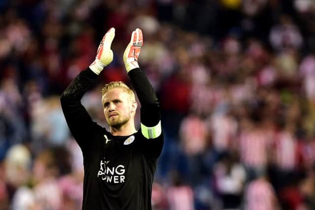 Captain Kasper Schmeichel salutes the Leicester supporters at the final whistle. Schmeichel played a starring role for City, who were forced on to the back foot for much of the game by Atletico. Picture: Gerard Julien/AFP/Getty Images