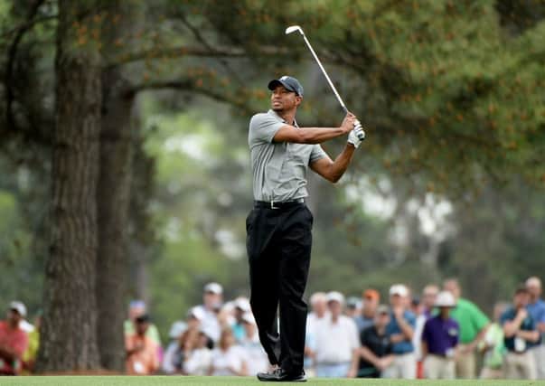 Tiger Woods hits his second shot on the 15th hole during the first round of the 2013 Masters. The event was the first Bytheminute reported on. Picture: Harry How/Getty
