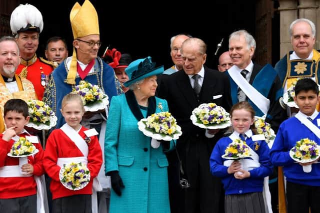 The Queen  II and Prince Philip  pose with Yeoman of the Guard following the Royal Maundy service (Photo: AFP PHOTO / POOL / Anthony Devlin)