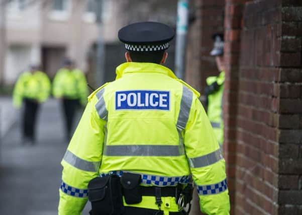 Police officers carried out door-to-door inquiries in the area, and have now arrested a man in connection with the death. Picture: John Devlin