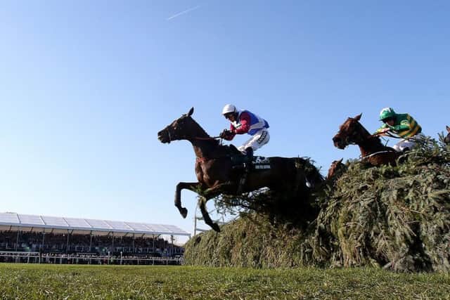 One For Arthur, ridden by jockey Derek Fox, jumps the last fence on the way to winning the 2017 Grand National and becoming the first Scottish-trained winner since 1979. Picture: Niall Carson/PA Wire