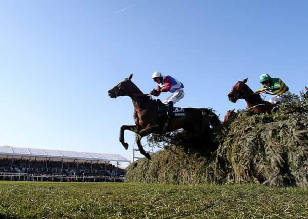 One For Arthur, ridden by jockey Derek Fox, jumps the last fence on the way to winning the 2017 Grand National and becoming the first Scottish-trained winner since 1979. Picture: Niall Carson/PA Wire