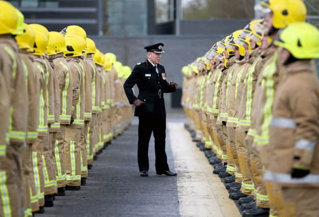 Assistant Chief Officer Lewis Ramsay inspects some of the 101 new full-time firefighters who have graduated (Photo Jane Barlow/PA Wire)