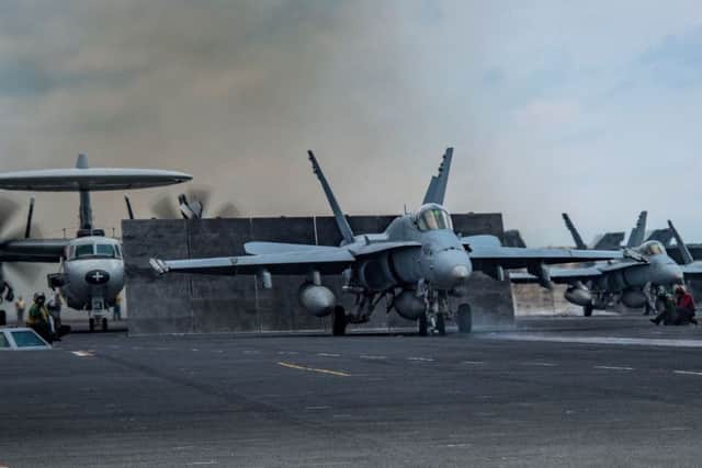 An F/A-18C Hornet assigned to the Blue Blasters  of Strike Fighter Squadron (VFA) 34 as it prepares to launch from the aircraft carrier USS Carl Vinson in the South China Sea. (photo: AFP PHOTO / US NAVY / MCSA)