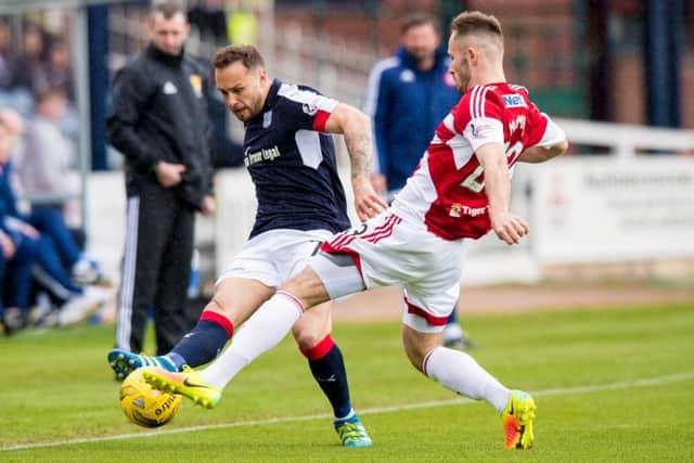 Dundee's Tom Hatley in action against Hamilton's Scott McMann. Pic: SNS/Ross Parker