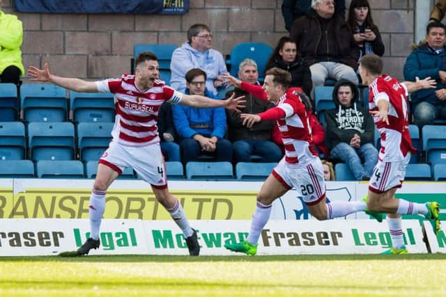 Michael Devlin celebrates Hamilton's second goal. Pic: SNS/Ross Parker