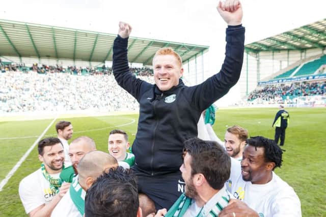 Neil Lennon  celebrated with his Hibs players after promotion was clinched on Saturday. Picture: SNS.
