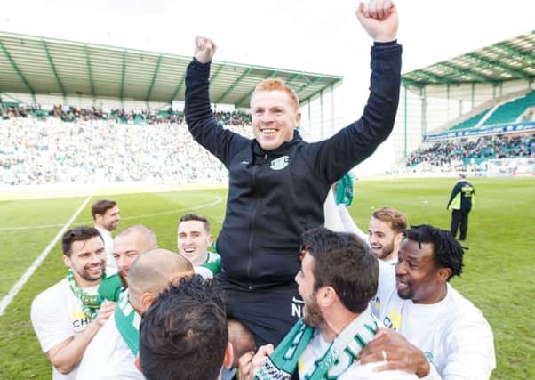 Neil Lennon  celebrated with his Hibs players after promotion was clinched on Saturday. Picture: SNS.