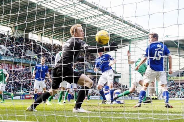 Darren McGregor scores his second goal of the game as Hibs clinched promotion on Saturday. Picture: SNS.