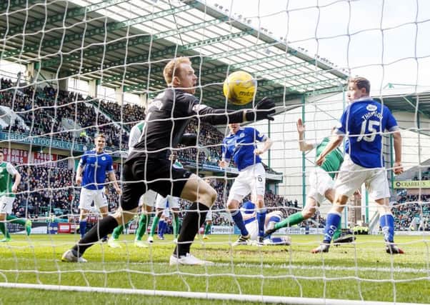 Darren McGregor scores his second goal of the game as Hibs clinched promotion on Saturday. Picture: SNS.