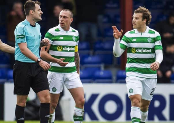 Celtic's Scott Brown appeals to the referee after Ross County are awarded a penalty. Picture: SNS