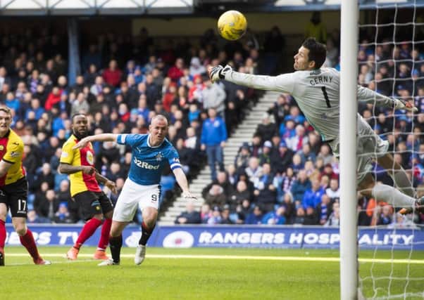 Rangers striker Kenny Miller opens the scoring as his header flies past Tomas Cerny in the Partick goal. Picture: Rob Casey/SNS