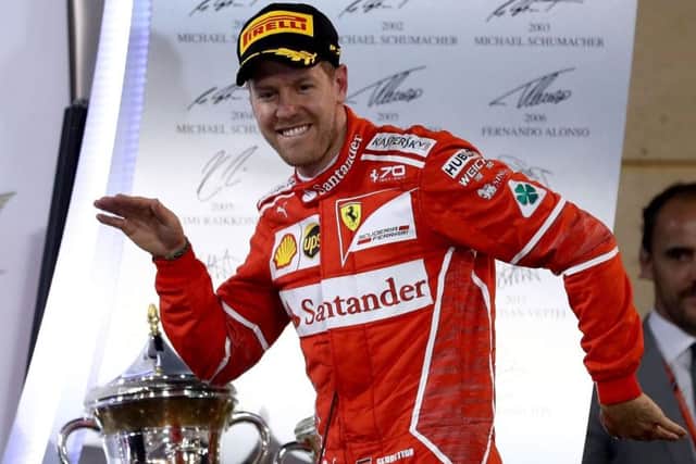 Sebastian Vettel celebrates victory with a dance on the podium. Picture: Lars Baron/Getty Images