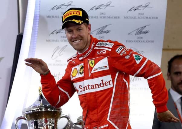Sebastian Vettel celebrates victory with a dance on the podium. Picture: Lars Baron/Getty Images