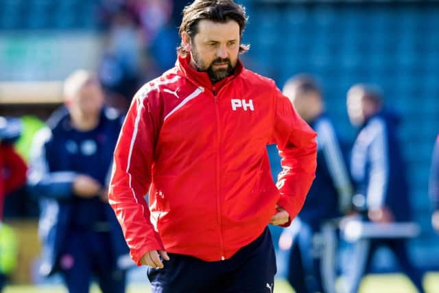 A crestfallen Paul Hartley walks off after Dundee's defeat to Hamilton. Picture: SNS