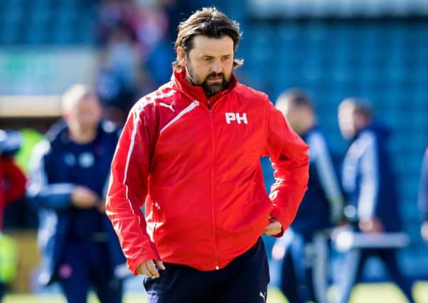 A crestfallen Paul Hartley walks off after Dundee's defeat to Hamilton. Picture: SNS
