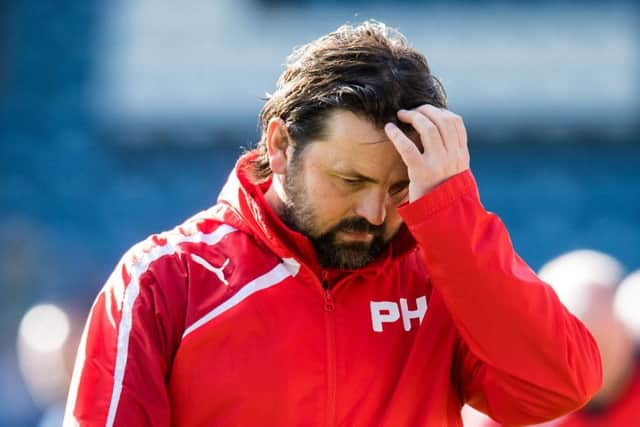 Dundee manger Paul Hartley cuts a dejected figure after seeing his side fall to a 2-0 defeat at home to Hamilton - their seventh successive defeat.