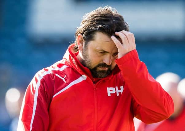 Dundee manger Paul Hartley cuts a dejected figure after seeing his side fall to a 2-0 defeat at home to Hamilton - their seventh successive defeat.