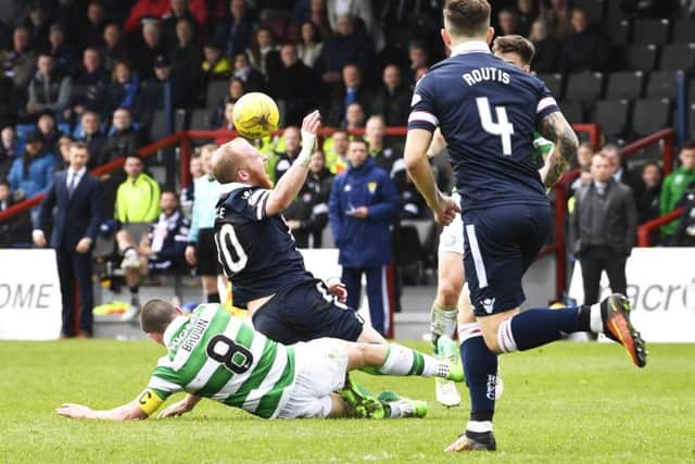 Celtic's Scott Brown is shown a straight red card for his challenge on Ross County's Liam Boyce. Picture: SNS