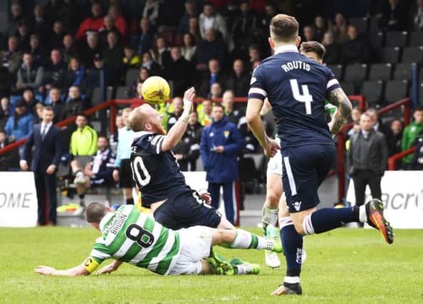 Celtic's Scott Brown is shown a straight red card for his challenge on Ross County's Liam Boyce. Picture: SNS