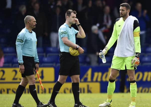 Craig Gordon, right, approaches referee Don Robertson at full-time. Picture: SNS