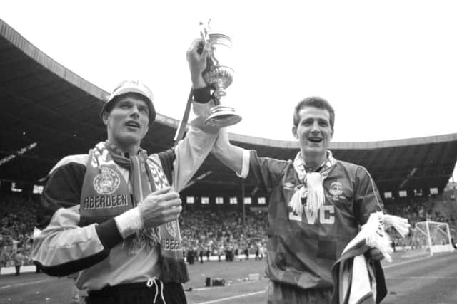 Dons' Theo Snelders and Brian Irvine, holding the trophy in 1990. Picture: Brian Stewart