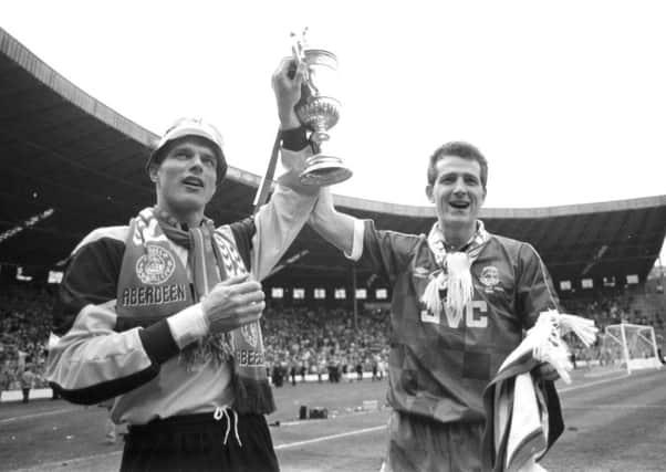 Dons' Theo Snelders and Brian Irvine, holding the trophy in 1990. Picture: Brian Stewart