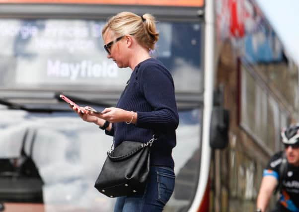 Video footage of a busy junction showed people crossing the road while distracted by their mobile phones. Picture: Toby Williams