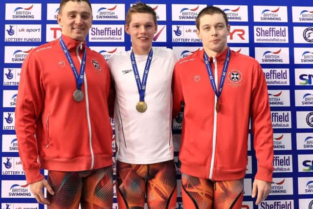 Gold medallist Duncan Scott, centre, alongside Jack Thorpe, left, who claimed silver, and Kieran McGuckin whose bronze medal secured a Scottish 1-2-3 in the 100m freestyle final at Ponds Forge. Picture Tim Goode/PA Wire