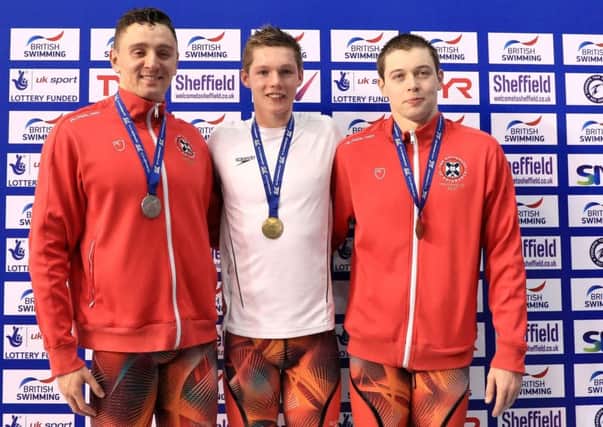 Gold medallist Duncan Scott, centre, alongside Jack Thorpe, left, who claimed silver, and Kieran McGuckin whose bronze medal secured a Scottish 1-2-3 in the 100m freestyle final at Ponds Forge. Picture Tim Goode/PA Wire