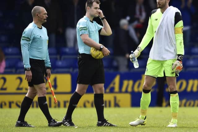 Referee Don Robertson (centre) erroneously awarded Ross County a penalty at the end of last weekend's clash with Celtic. Picture: SNS